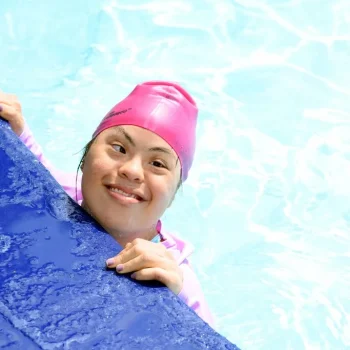 Young disabled girl participant in community at swimming school